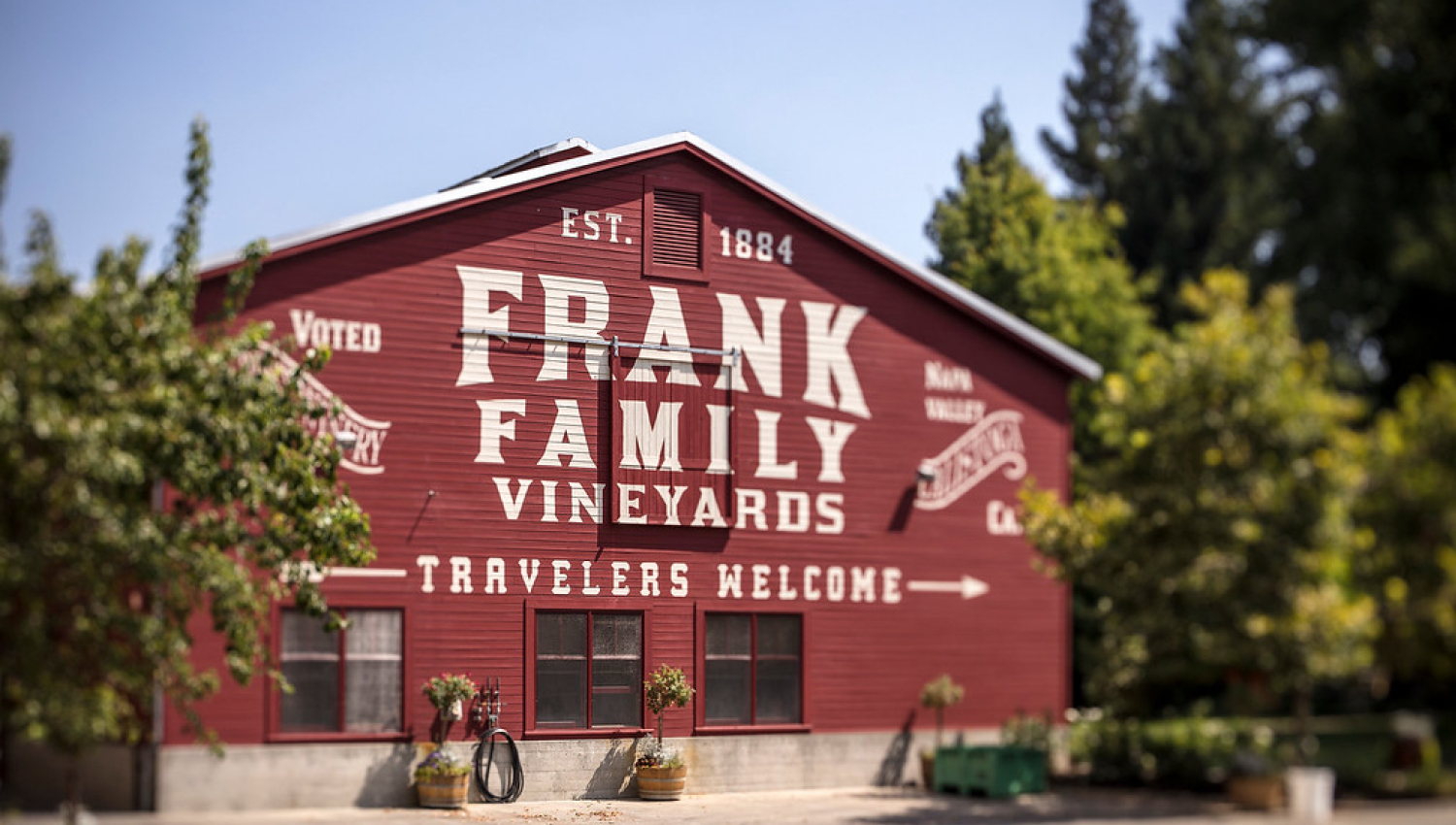 Frank Family Vineyards, Travelers Welcome printed on a building.
