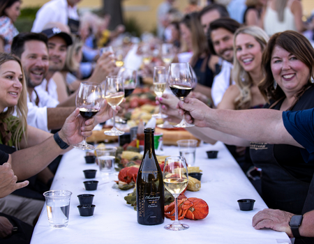 Guests toasting with a glass of Chardonnay