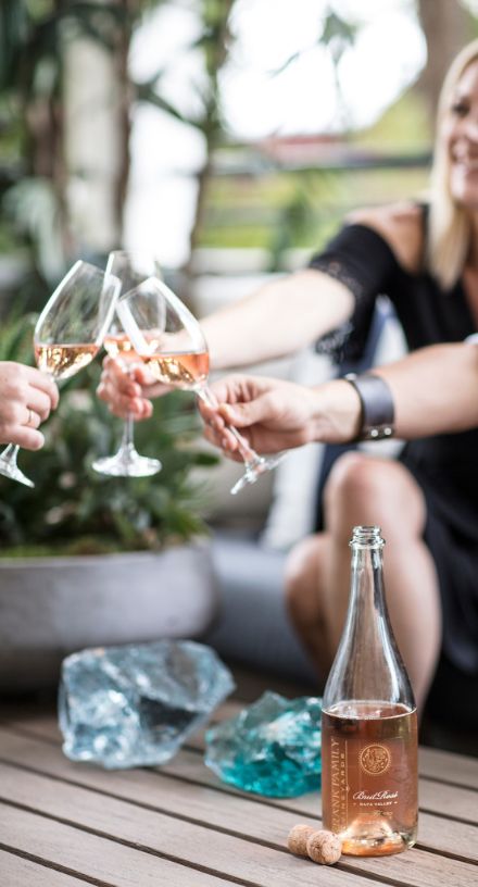 Guests toasting with glasses of Brut Rosé