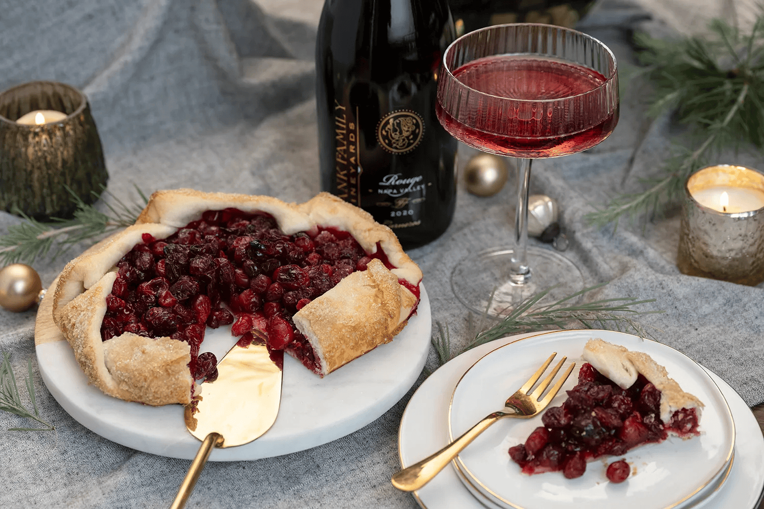 A plate with Cranberry Galette served in top next to a bottle and glass of Frank Family's Sparkling Rouge.