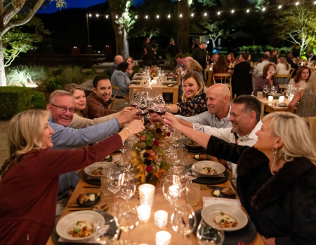 Guests cheersing at Harvest Dinner. 