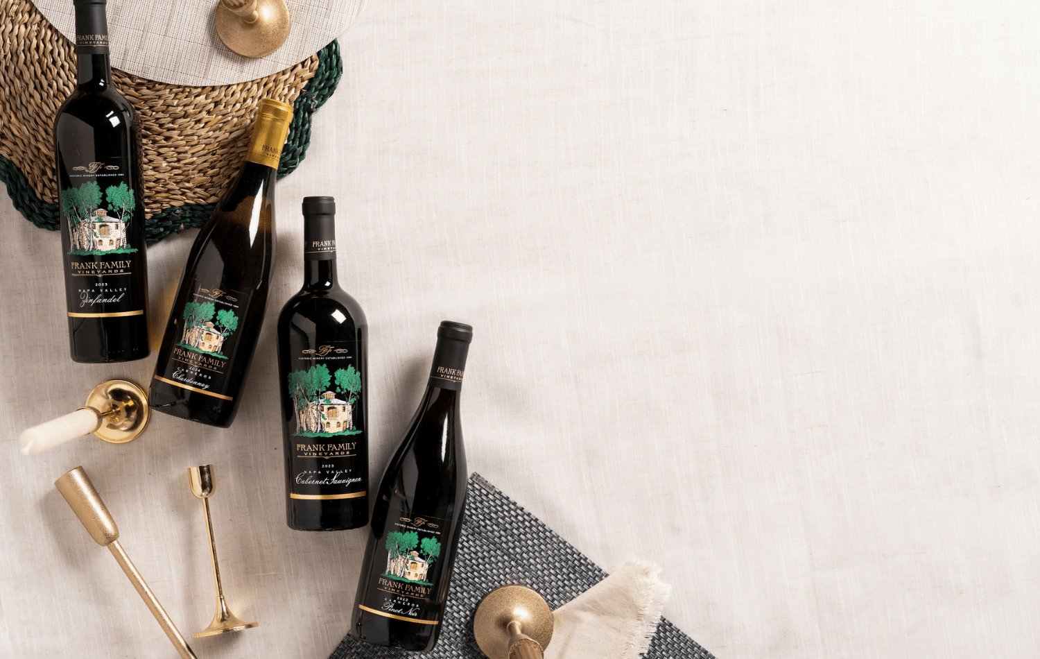 A collection of Chardonnay, Pinot Noir, Zinfandel, and Cabernet set against a hosting setting. 