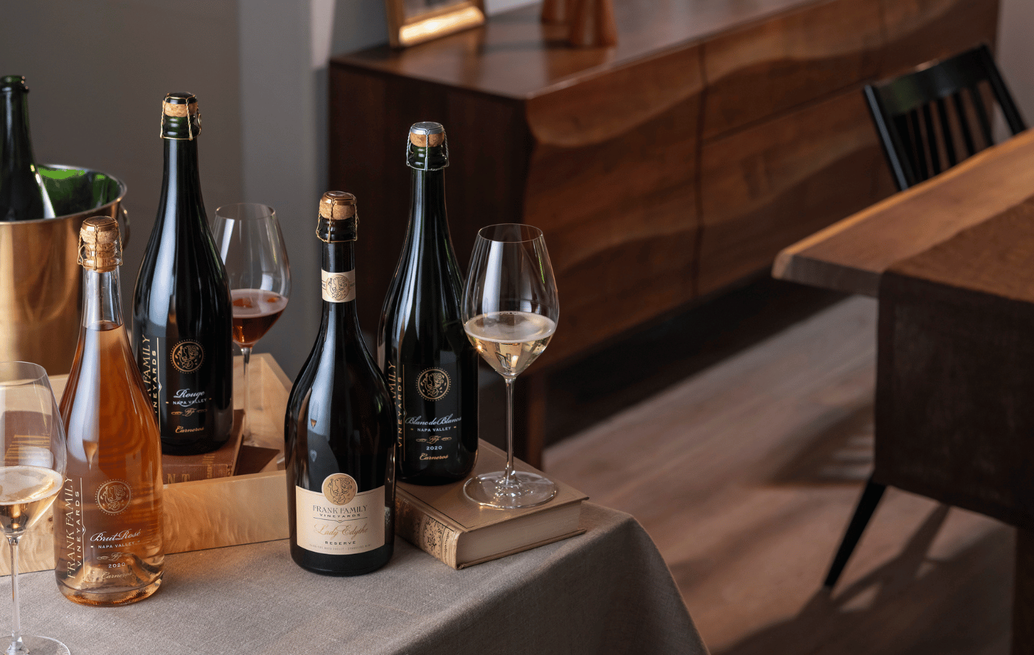 An assortment of Frank Family sparkling wines against a fall backdrop. 