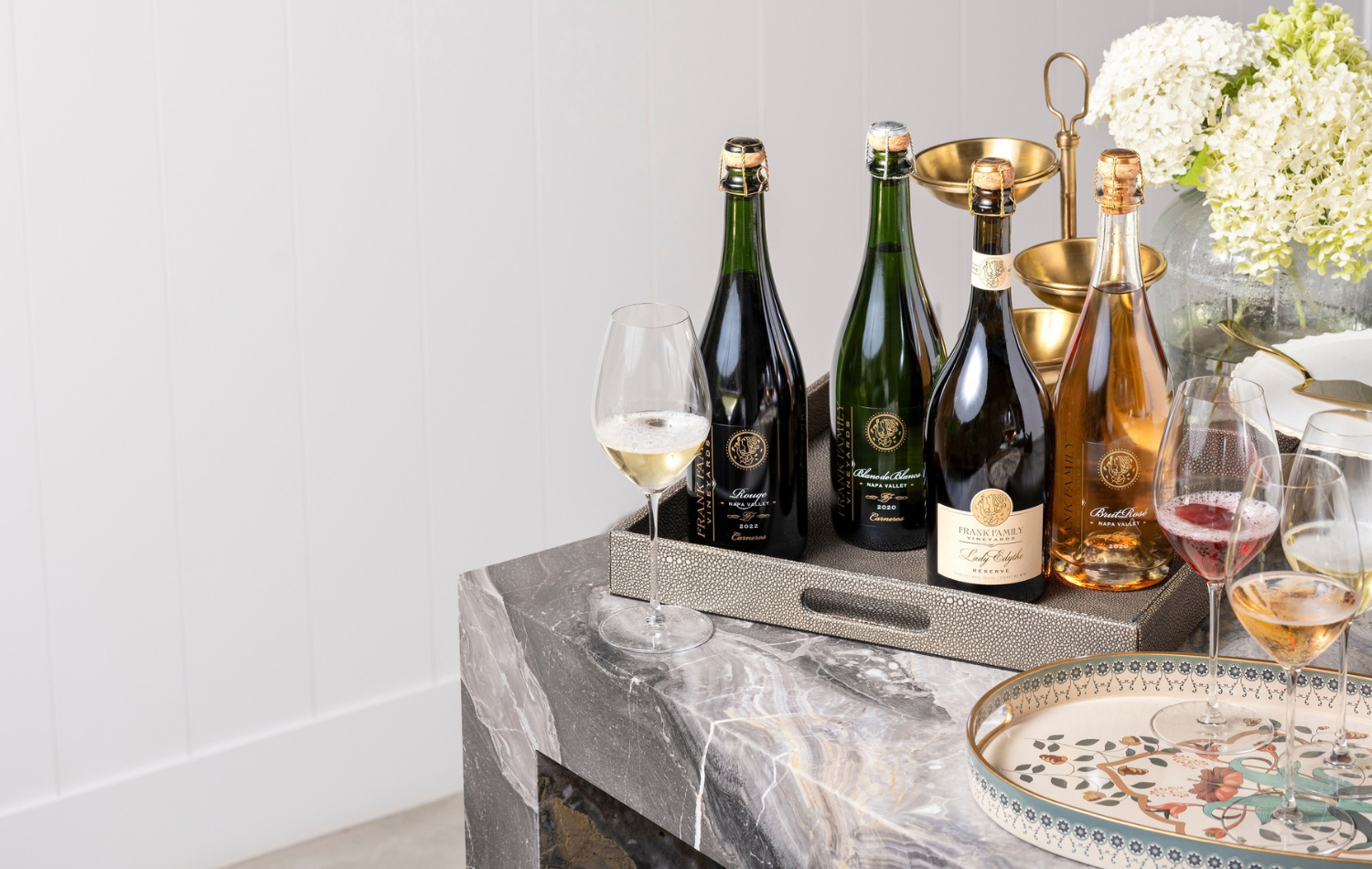 An assortment of Frank Family sparkling wines with various serving platters. 