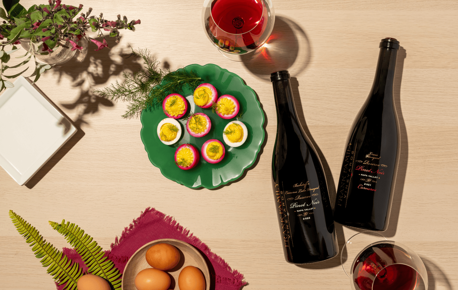 Two bottles of Frank Family Pinot Noir alongside a Spring recipe. 