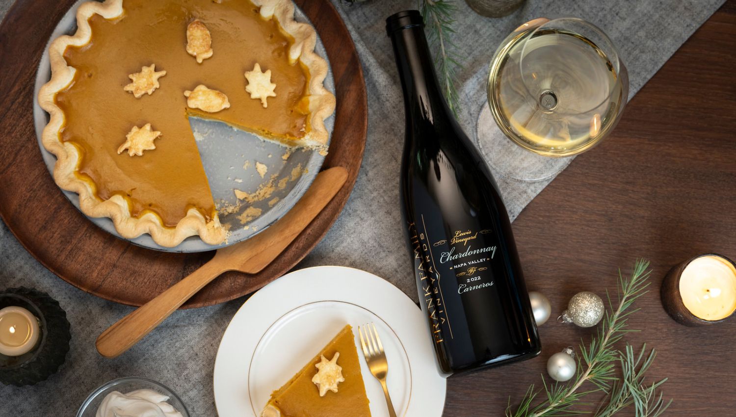 A bottle of Lewis Vineyard Chardonnay alongside a piece of pumpkin pie